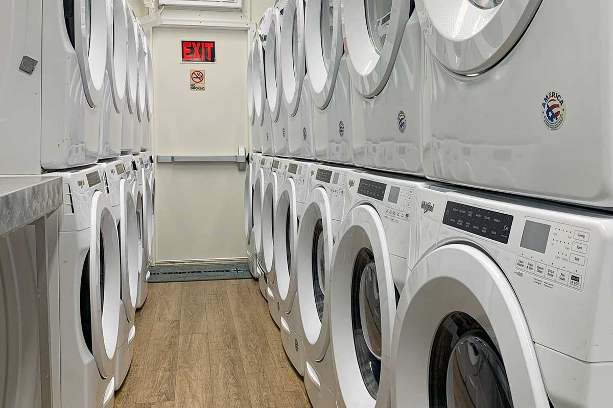 Rows of washing machines in a laundry trailer.