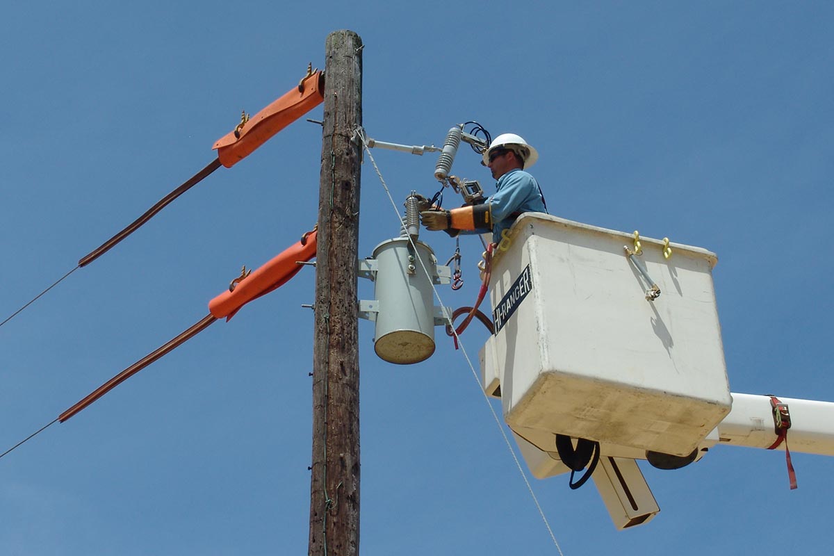 A lineman makes the necessary connections.